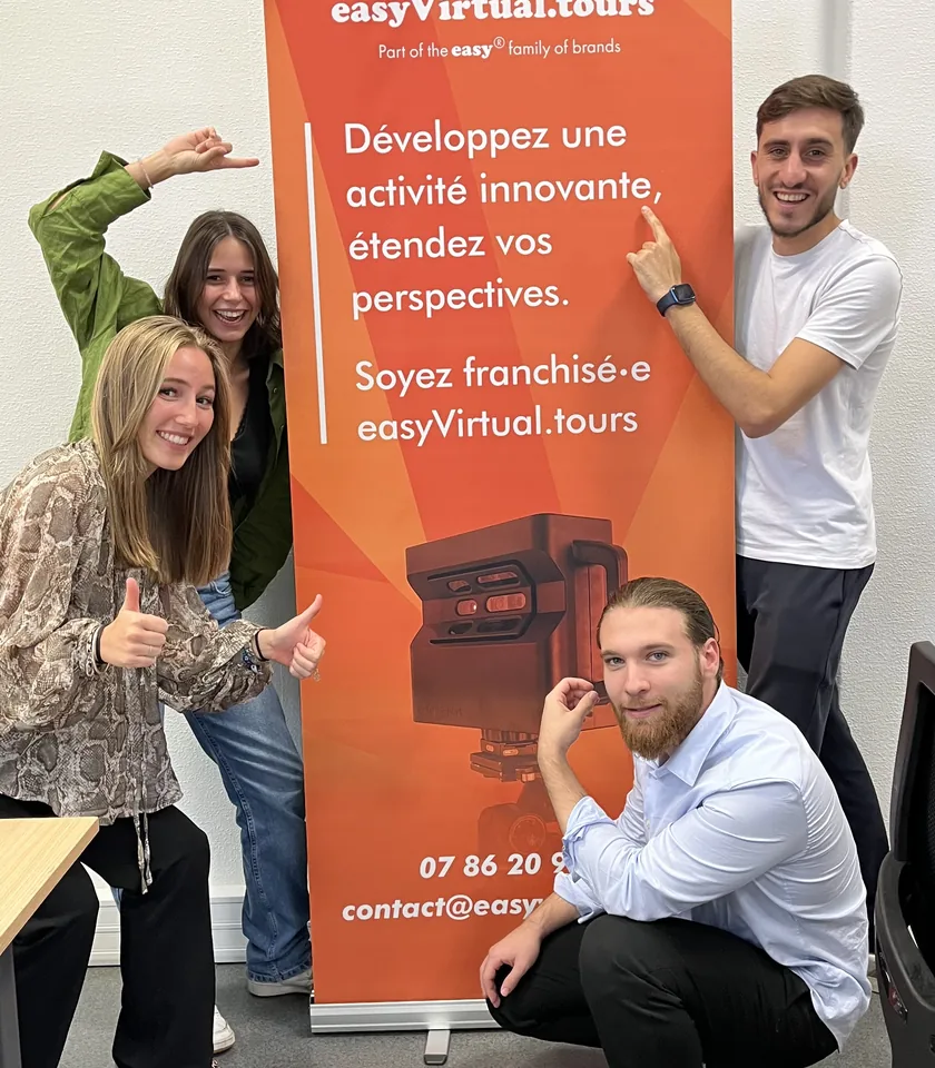 The team in front of the easyVirtual.tours banner after the entrepreneurship competition.