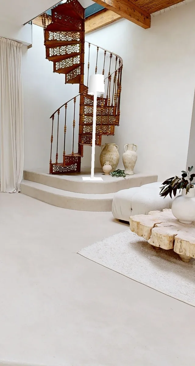 HD photo of a living room with a spiral staircase, taken from the tour
