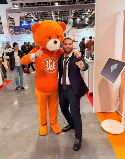 The easyBear mascot and a network member at a trade show