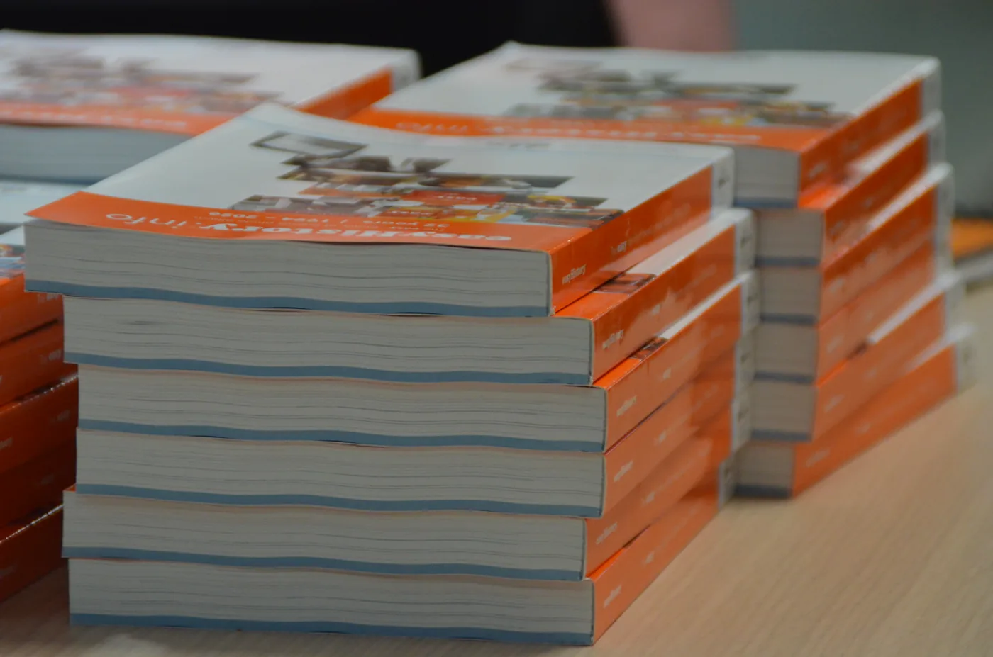 Stacks of orange sales brochures from the easyVirtual.tours network