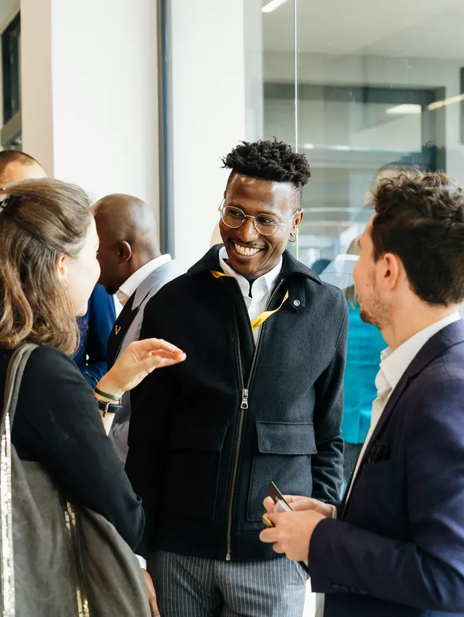 Professionals chatting and smiling at an after-work networking event